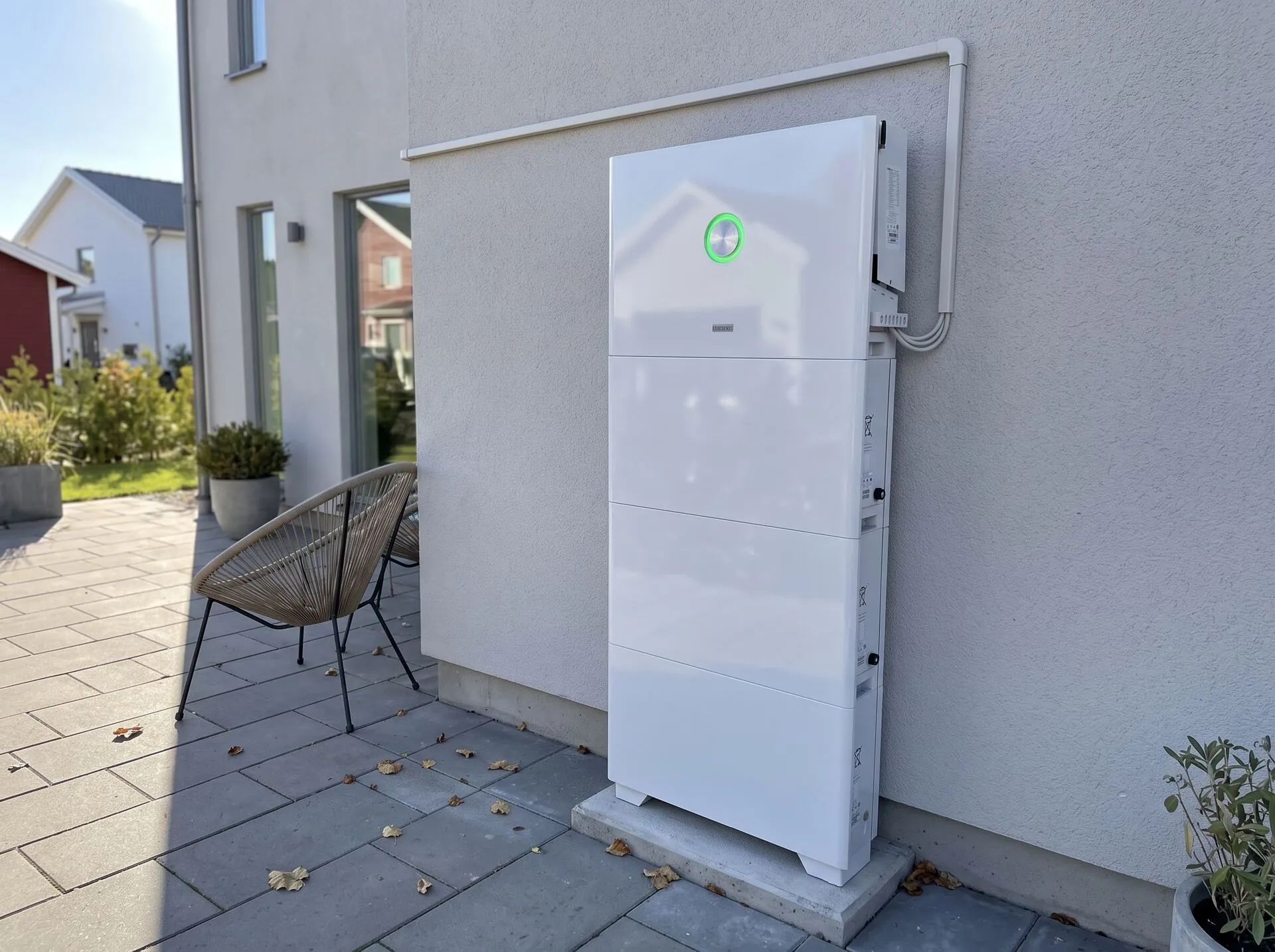 SAJ HS3 batteri monterat på fasad bredvid sittgrupp på terrass